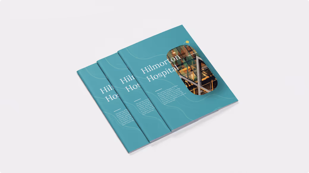 Three teal brochures titled 'Hilmorton Hospital' stacked with a construction-themed image on the top right corner of the front brochure.